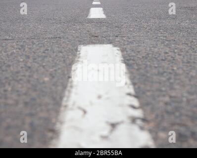 close-up dotted line on an empty street, a line extending into the distance.selective focus Stock Photo