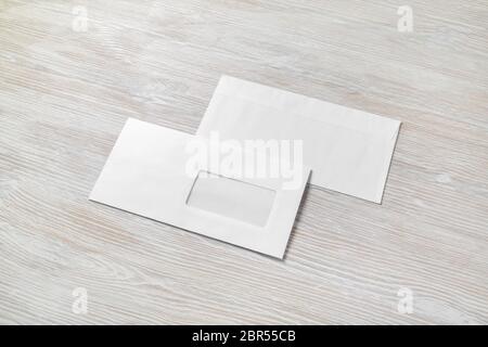Photo of two blank paper envelopes on light wooden background. Back and front. Stock Photo