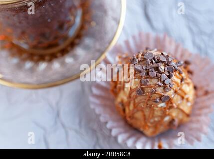 Top view of the cake from condensed milk and a glass cup of coffee on the table. Close up image Stock Photo