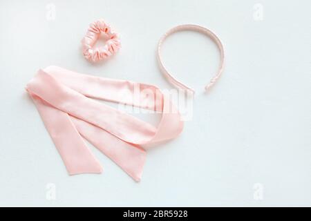silk pink rounded hairband isolated on white. Flat lay Hairdressing tools and accessories as Hair Scrunchie, Elastic Hair Bands, Bobble Sports Stock Photo
