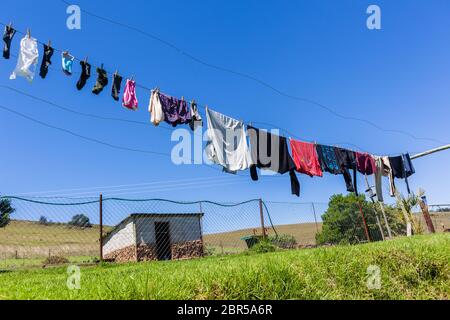 Farm washing clothes drying lines rural lifestyle landscape. Stock Photo