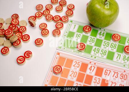 Wooden kegs, cards and chips for playing lotto on a white background Stock Photo