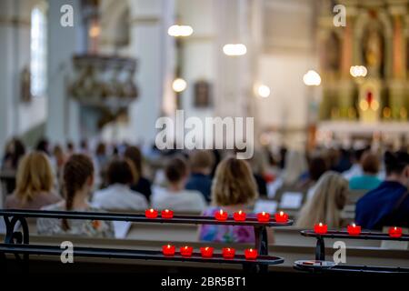 Wedding marriage ceremony in church. Burning candles in the church during the wedding ceremony. Christian church decorated from candles for wedding ma Stock Photo