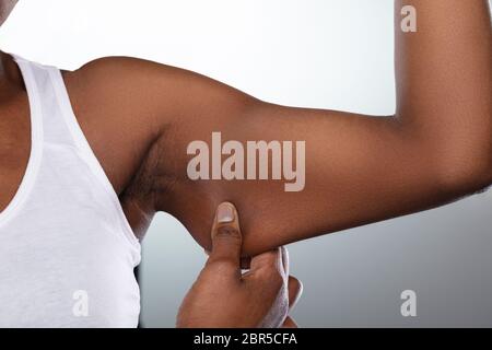 Woman flexing her biceps hi-res stock photography and images