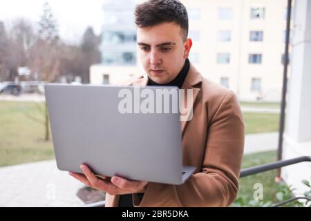 Concentrated young guy looking at a laptop Stock Photo