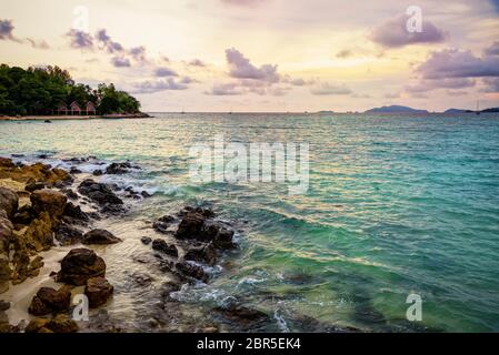 Beautiful tropical nature landscape colorful the sky at sunset over the sea rocks and resort on the beach in summer at the Sunset Beach on Koh Lipe is Stock Photo