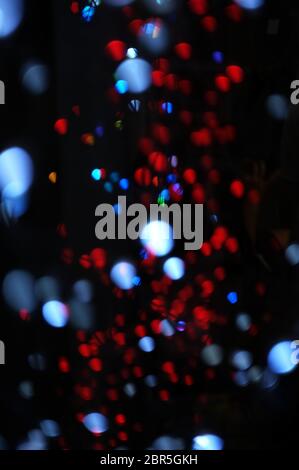 Blurred LED screen closeup. Glowing threads in a color spectrum on a black background. Stock Photo