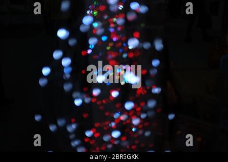 Blurred LED screen closeup. Glowing threads in a color spectrum on a black background. Stock Photo