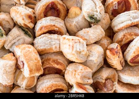Mix of delicious appetizers. Small pizzas made of puff pastry. Stock Photo