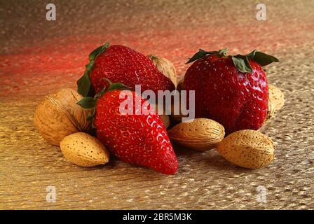 mix the collection of dried fruit and strawberries on yellow and red light Stock Photo