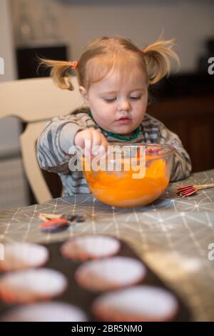 1 & 3 year old making cakes Stock Photo