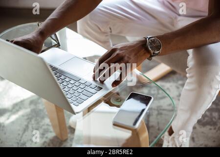 Close-up of male fingers typing a business document, note or search key on the laptop. Business, finance, education, working and online shopping concept. Preparing for online conference, videocall. Stock Photo