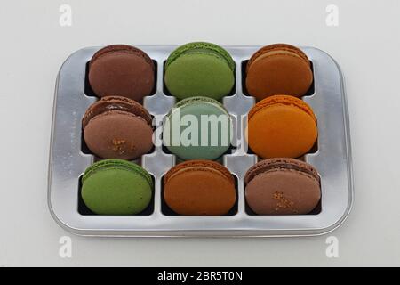 Nine Colourful French Macarons in a Tray Stock Photo