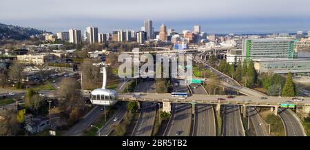 The cable car is full of riders exploring Portland via aerial trensportation Stock Photo