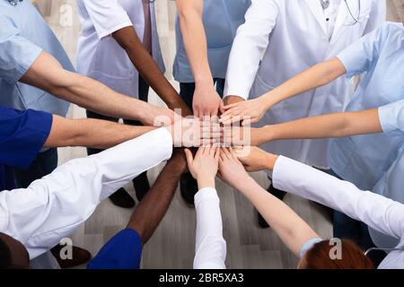 Directly Above Shot Of Medical Team Stacking Hands Together At Hospital Stock Photo