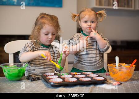 1 & 3 year old making cakes Stock Photo