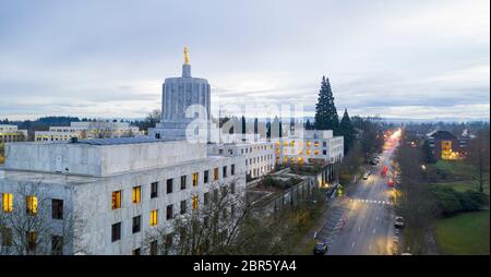 The state capital building adorned with the Oregon Pioneer with downtown Salem in the background Stock Photo