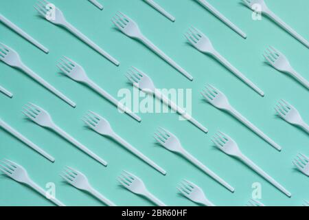 Plastic white forks on pastel blue background Stock Photo