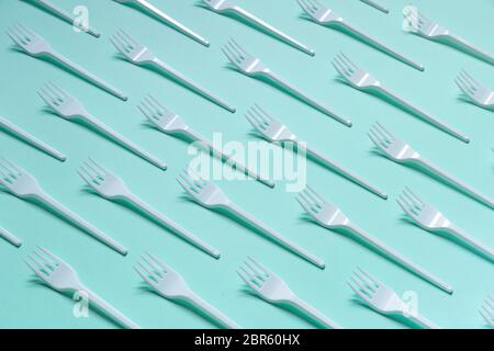 Plastic white forks on pastel blue background Stock Photo
