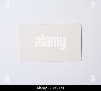 Rectangular empty paper card on wooden cross slice on old weathered ...