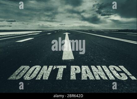 Dont Panic written on the road Stock Photo