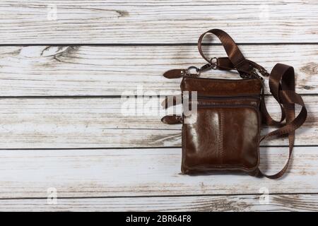 mens leather shoulder bag on wooden background Stock Photo