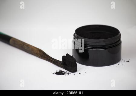 Charcoal on a toothbrush to whiten teeth beauty concept Stock Photo