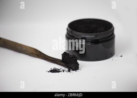 Charcoal on a toothbrush to whiten teeth beauty concept Stock Photo