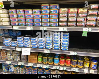 Orlando,FL/USA-5/3/20: A display of various cans of tuna and salmon in the canned foods department of a Whole Foods Market Grocery Store. Stock Photo