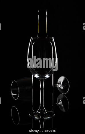 Wine bottle with wine glasses isolated on a black background. Stock Photo