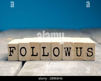 The words Follow us on a wooden blocks, social media concept Stock Photo