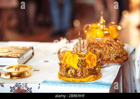 bible and golden crown of newlyweds in the church Stock Photo