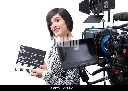 young woman holding a clapboard. video camera, Isolated on the white background Stock Photo