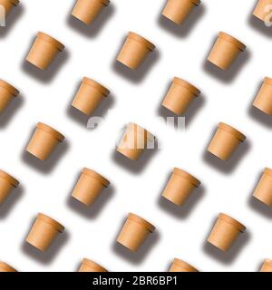 A seamless pattern of brown paper coffee cups is isolated on a white background. Stock Photo
