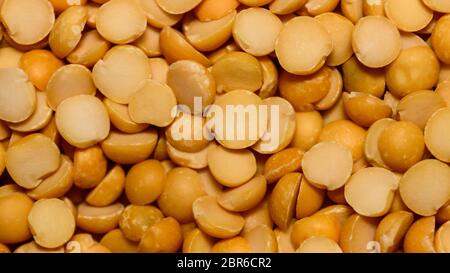 Close up pile of yellow Lentils beans texture, background pattern. Natural grains and cereals. Agricultural product concept. Seamless colorful canvas. Stock Photo