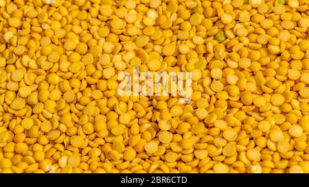 Close up pile of yellow Lentils beans texture, background pattern. Natural grains and cereals. Agricultural product concept. Seamless colorful canvas. Stock Photo