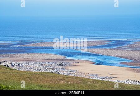 The River Ogmore running into the Bristol Channel at Ogmore by Sea on the Glamorgan Heritage Coast in South Wales. Photographed in Spring in May Stock Photo