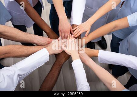Directly Above Shot Of Medical Team Stacking Hands Together At Hospital Stock Photo