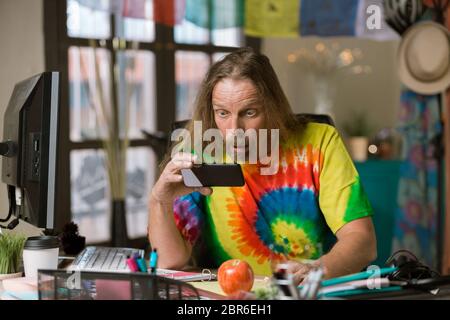 Surprised or shocked man looking at his phone Stock Photo