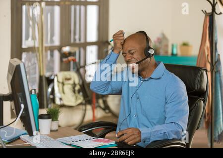 Stressed professional man working on a call Stock Photo