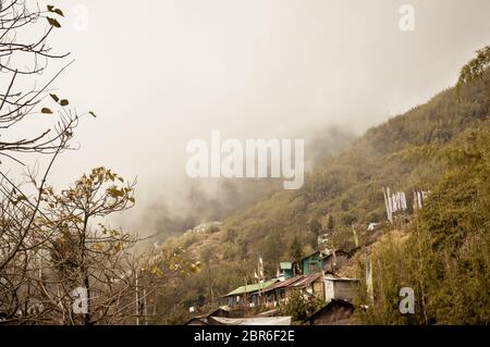 Fantastic beauty of town in hill slope of himalayas mountain, Dramatic cliffs surrond the town in a foggy winter day. Darjeeling West Bengal India. St Stock Photo