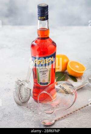LONDON, UK - MAY 20, 2020: Bottle of Aperol Aperitivo summer cocktail drink with empty glass and oranges on light table background. Stock Photo