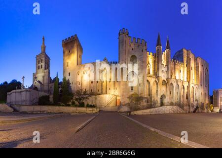 Palace of the Popes, once a fortress and palace, one of the largest and most important medieval Gothic buildings in Europe and Avignon Cathedral durin Stock Photo