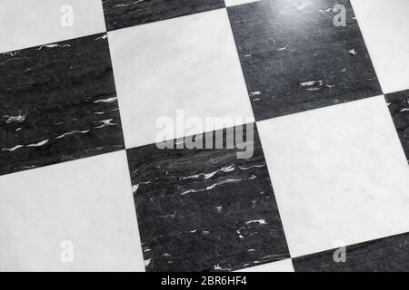 Marble floor tiling with classical black and white checkered pattern, close up Stock Photo