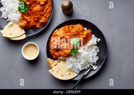 Paneer tikka masala with basmati rice. Indian cuisine, vegetarian dish made of soft cheese cubes cooked in spicy tomato sauce with cream. Top view. Stock Photo