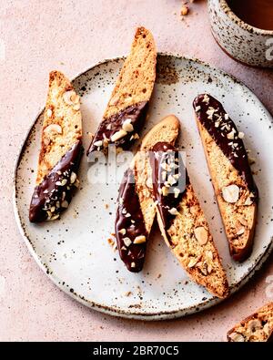Chocolate dipped hazelnut biscotti on a ceramic plate. Stock Photo