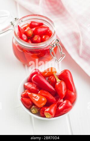 Pickled chili peppers in bowl. Stock Photo