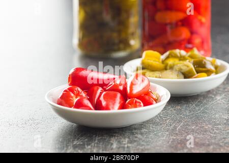 Pickled chili peppers in bowl. Stock Photo