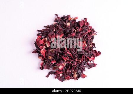 Pile of dry hibiscus karkade herbal tea isolated on white background, top view. Stock Photo