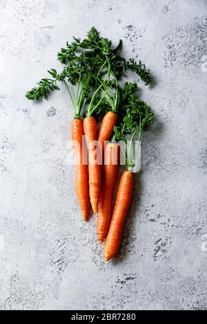 Fresh carrots on a textured blue background. Stock Photo